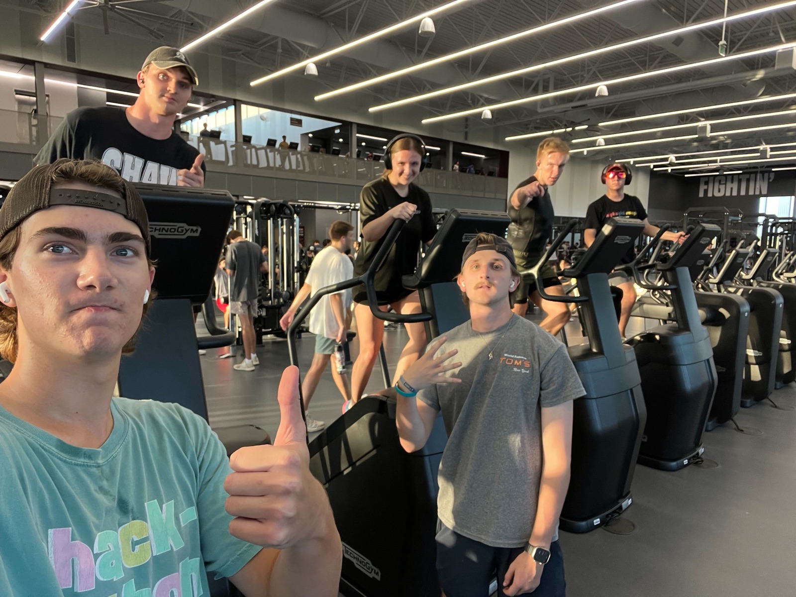 Nick and friends giving a thumbs up at the gym