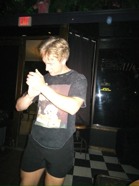 Nick dancing and laughing with a friend at a bar